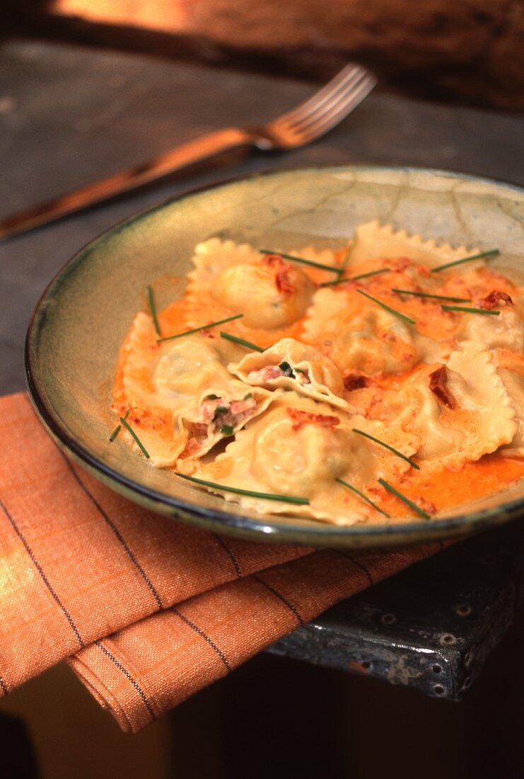 Ravioli with ham filling in tomato sauce