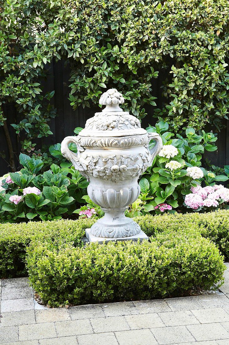 Trophy-shaped, antique Greek-style vessel in garden