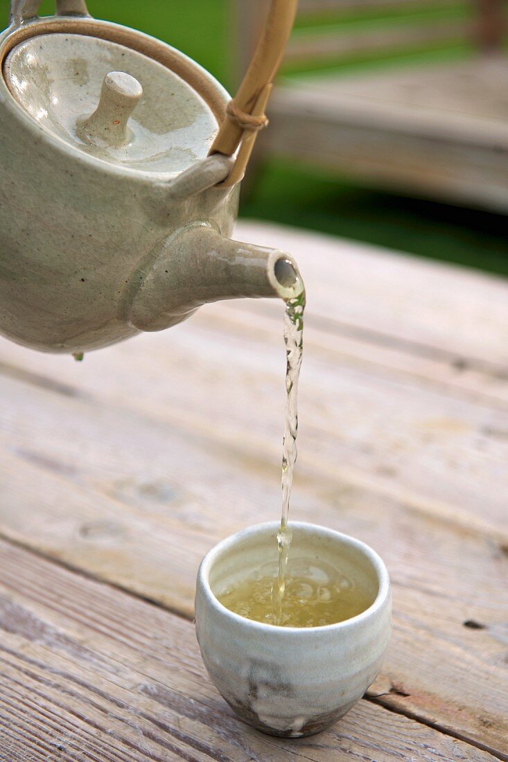 Hot lemon grass tea being poured into a bowl