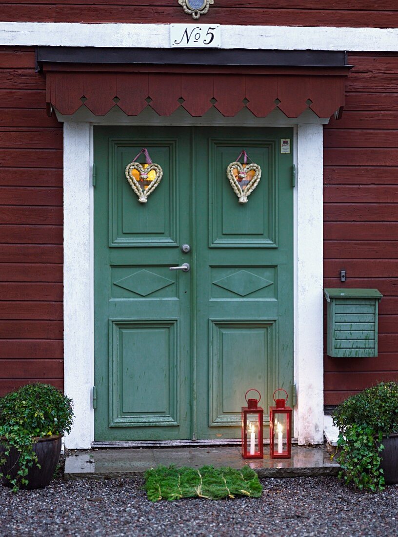 Front door (painted green) decorated with hearts