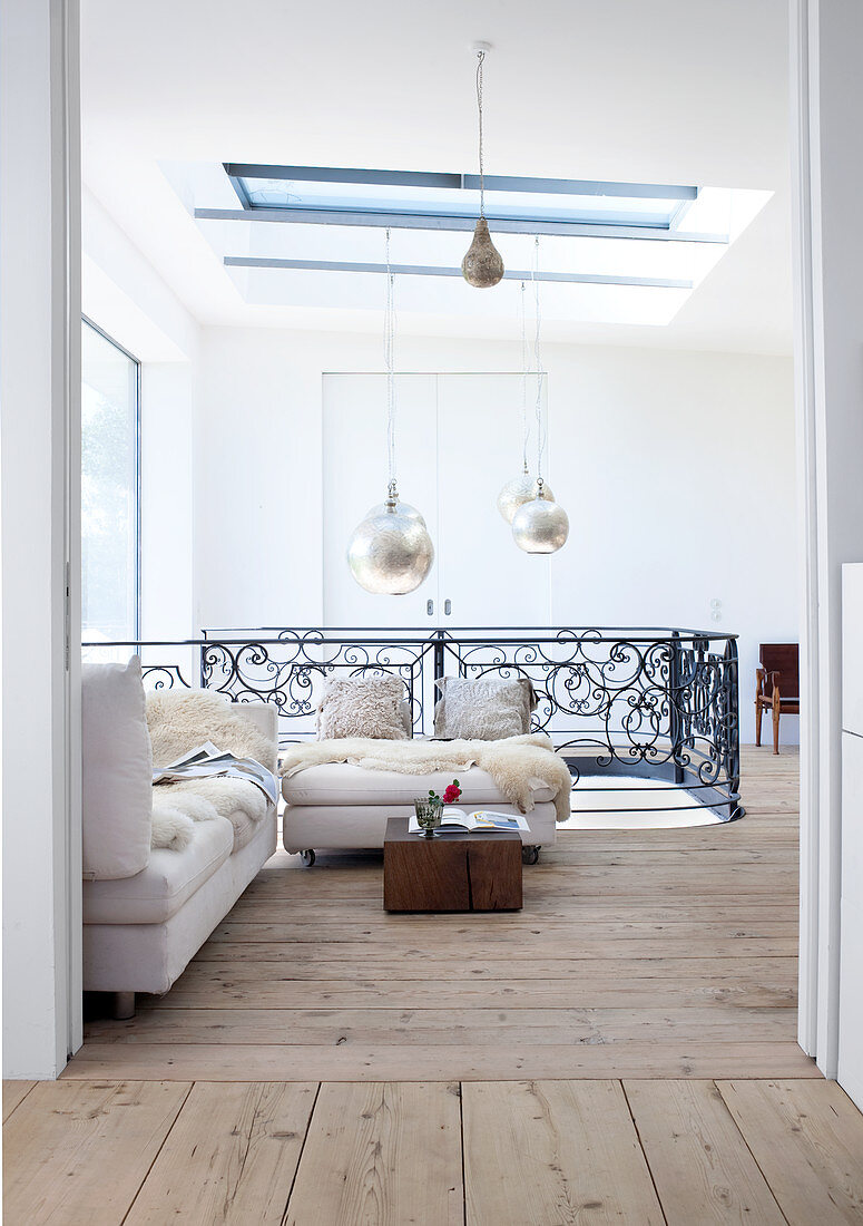 Bright seating area on upper storey of house with solid wooden floorboards