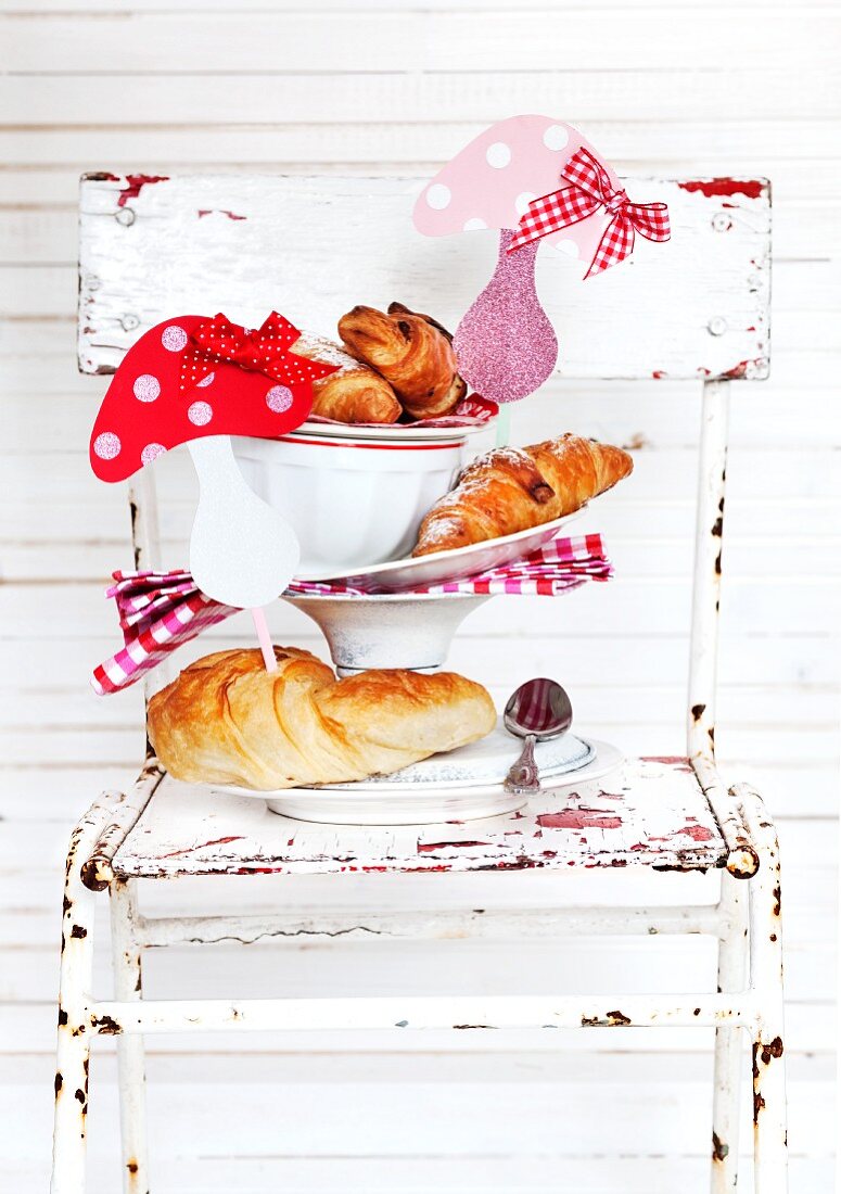 Fresh croissants decorated with cheerful decorative toadstools