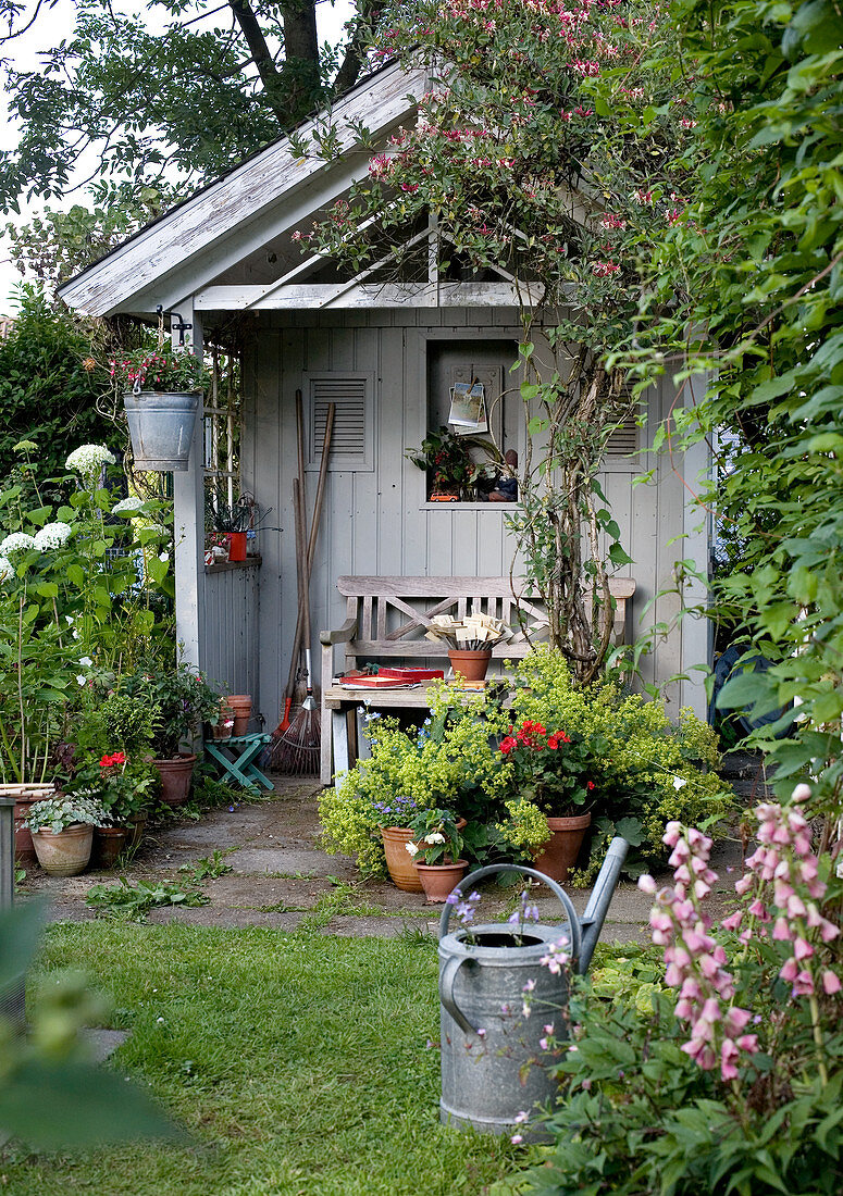 Seat in idyllic summer house in summery garden
