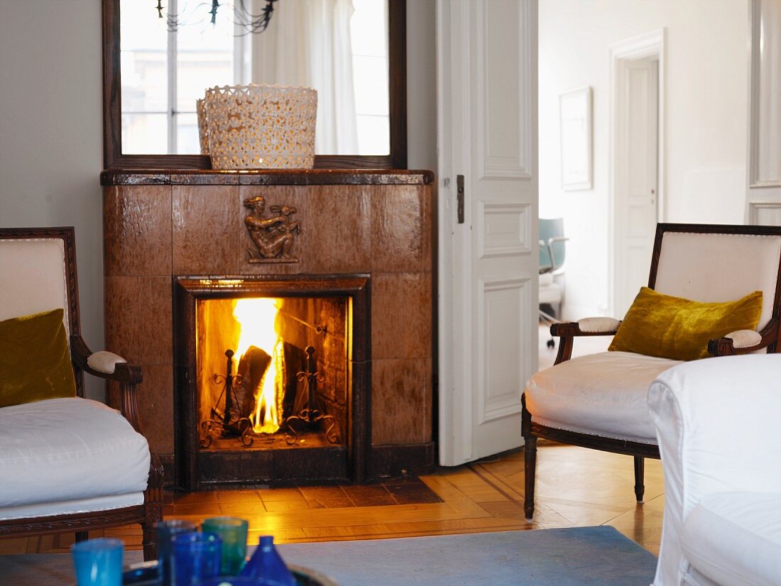 Antique upholstered furniture in front of a fireplace