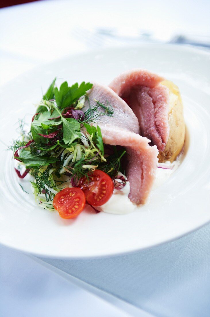 Soused herring with a baked potato and salad