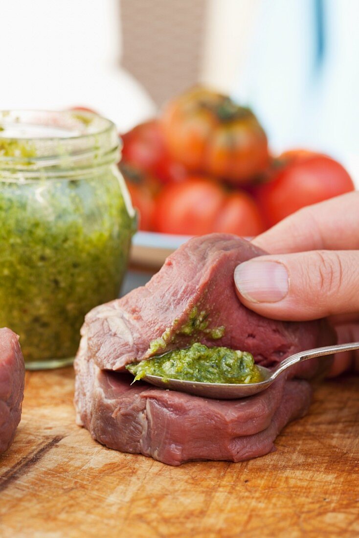 Beef fillet being filled with pesto