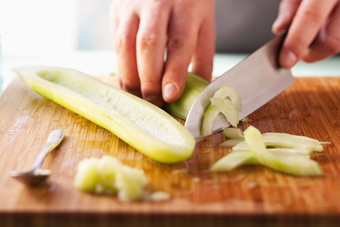 A deseeded cucumber being sliced