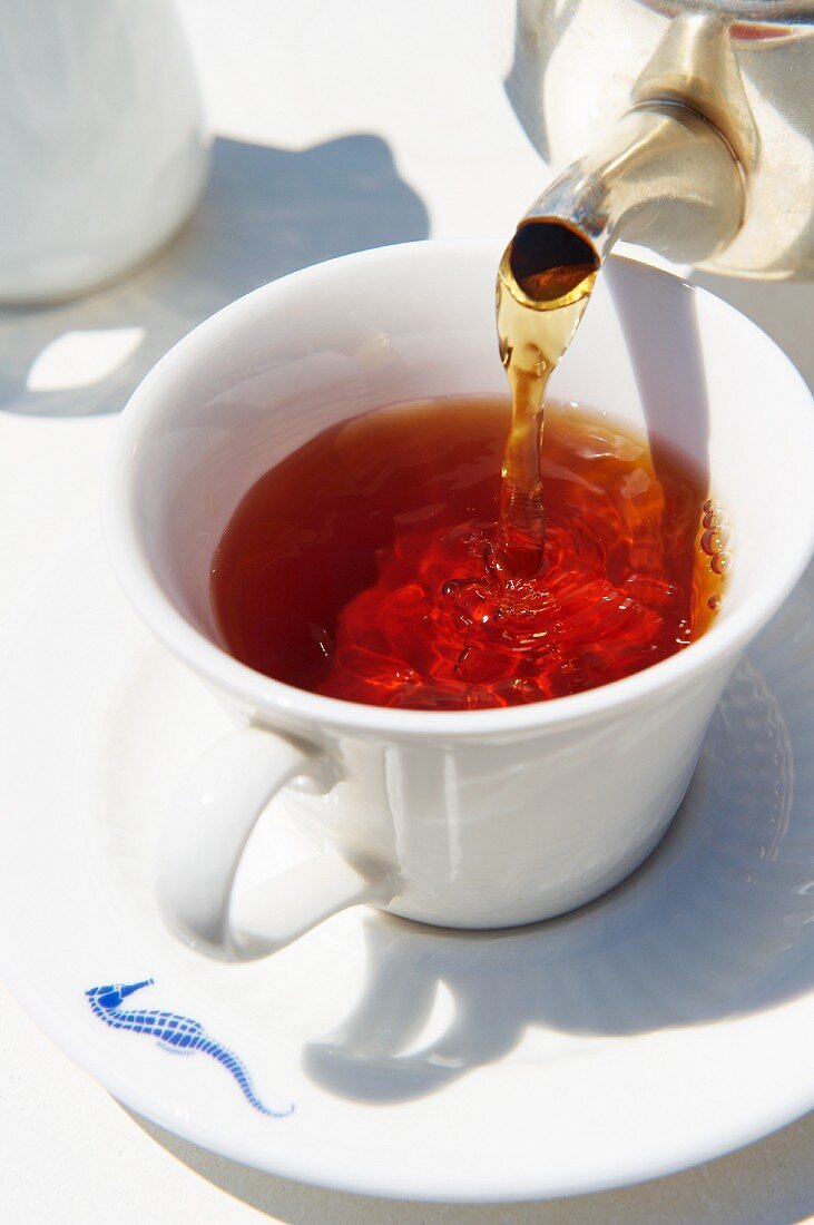 Tea being poured into a cup