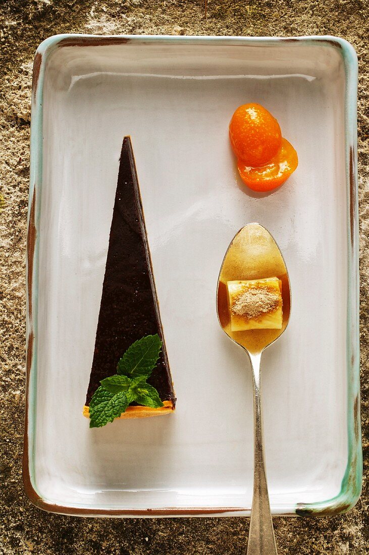 Chocolate tart with candied kumquats and pineapple bonbon