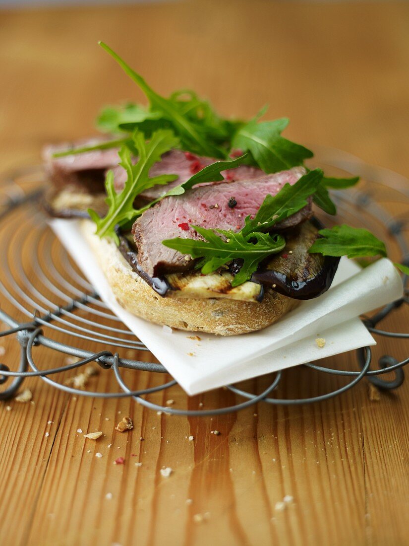 Open faced roll with rump steak, eggplant and rocket