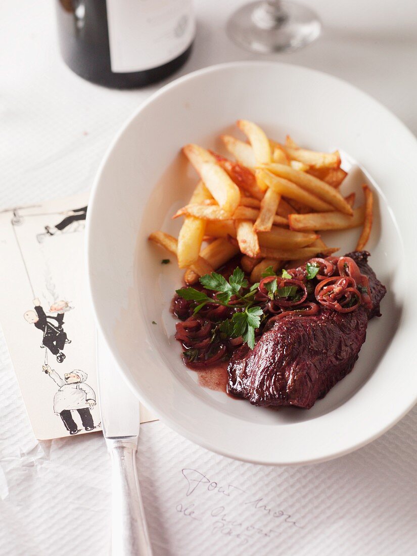 Onglet steak with onions and french fries