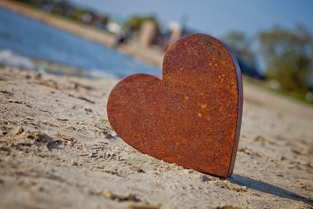 Rusty metal heart on the seashore