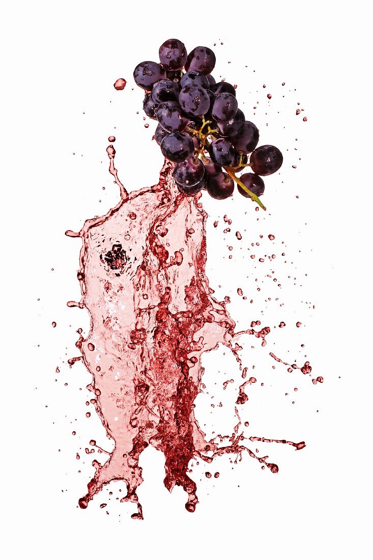 Red grapes with red wine splash