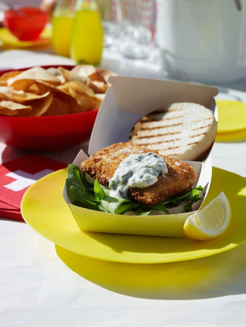 Fish burger and french fries at a summer party