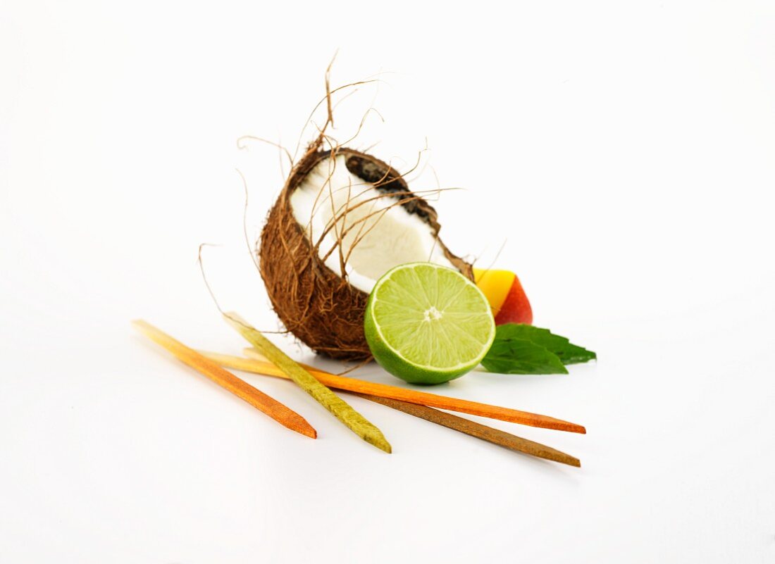 Wooden skewers, coconut, mango, Thai basil and limes