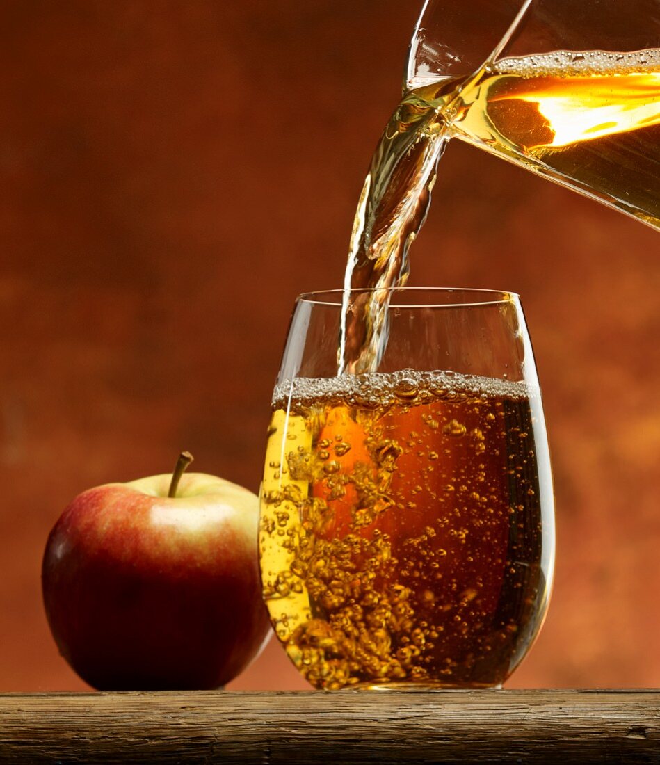 Pouring apple juice into a glass