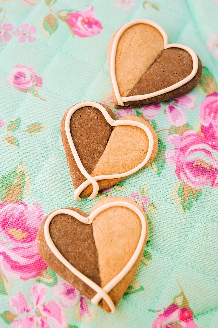 Three heart-shaped vanilla-chocolate cookies