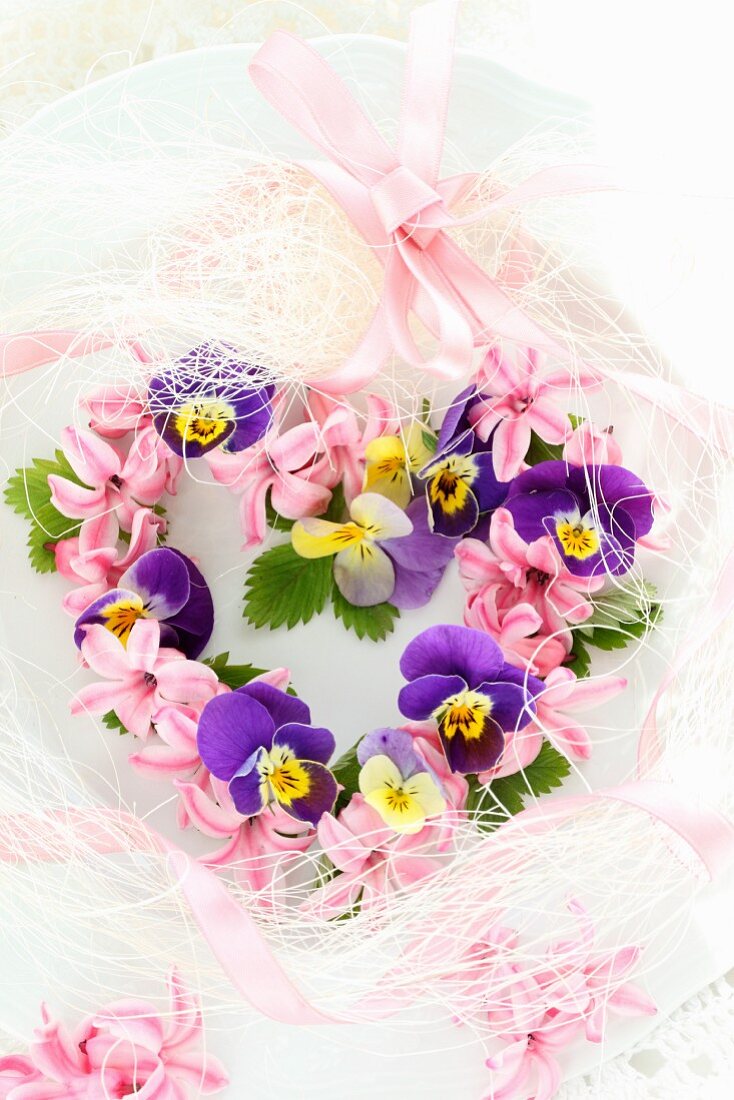 Heart-shaped flower wreath of violas and hyacinth florets