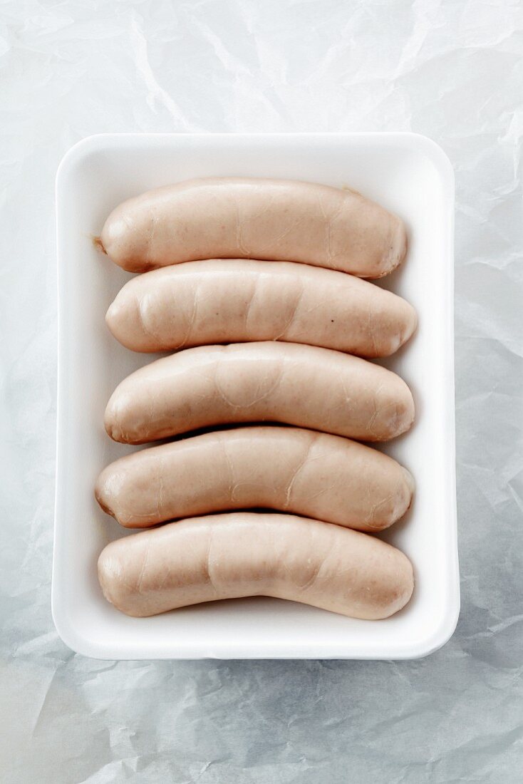 Raw White Sausages (Weisswurst) on a Styrofoam Tray