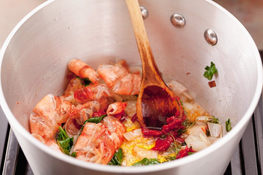Preparing prawn sauce: sweat prawn shells