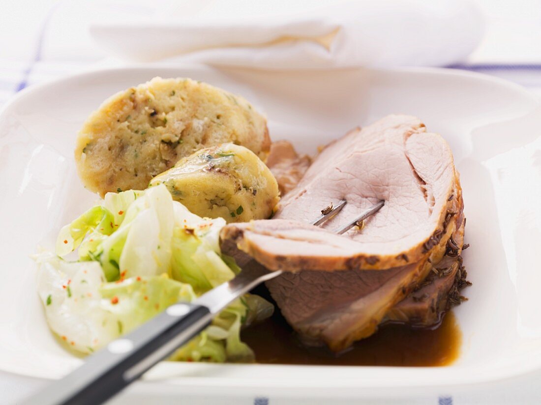 Roast pork with caraway, bread dumplings and white cabbage