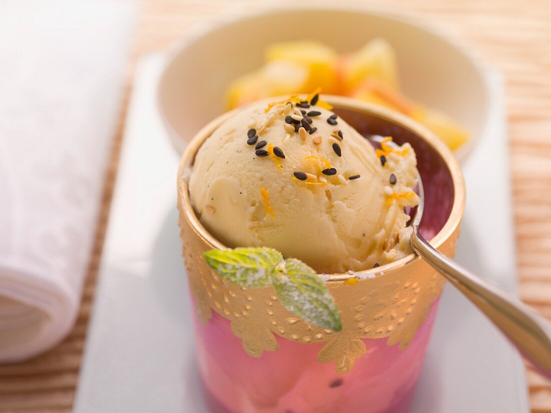 Vanilla and sesame ice cream garnished with ginger and fruit salad