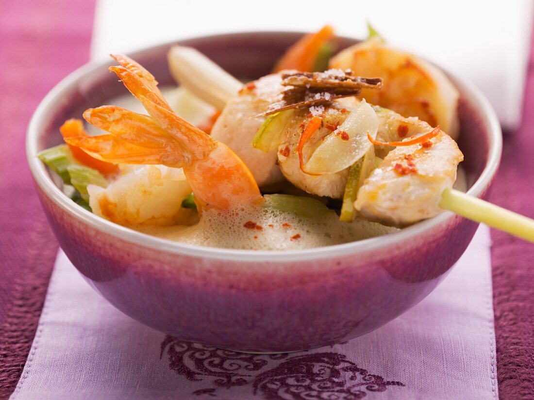 Thai coconut milk soup with prawns and a chicken and lemongrass skewer