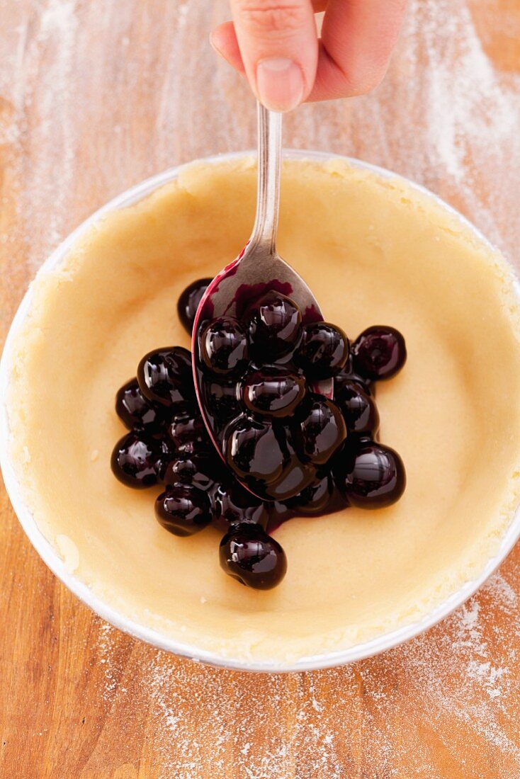 Spoon blueberries over shortcrust pastry base