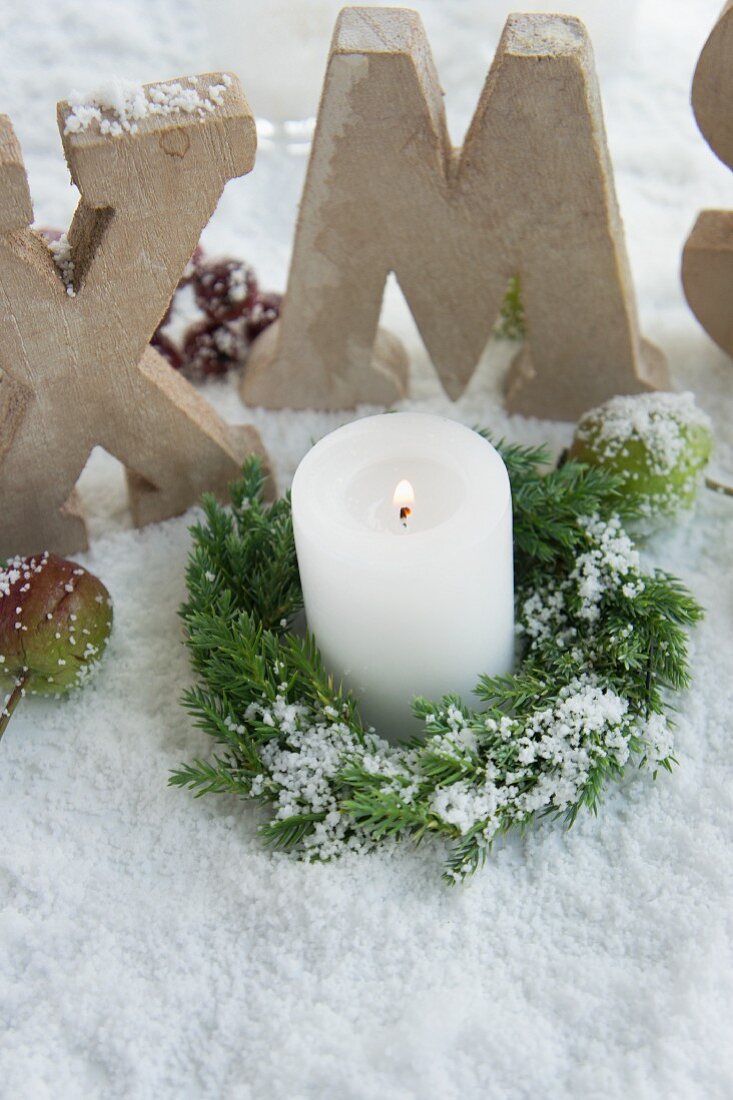 Christmas candle in the snow