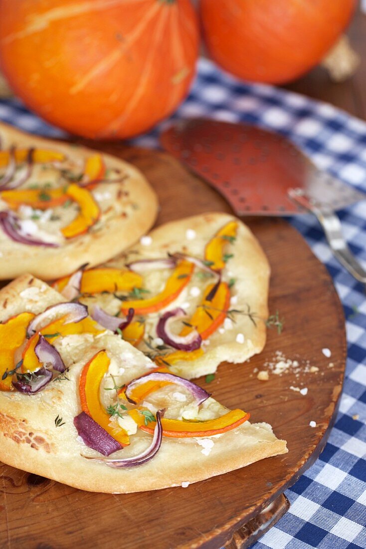 Tarte flambée with pumpkin, red onions and goat's cream cheese
