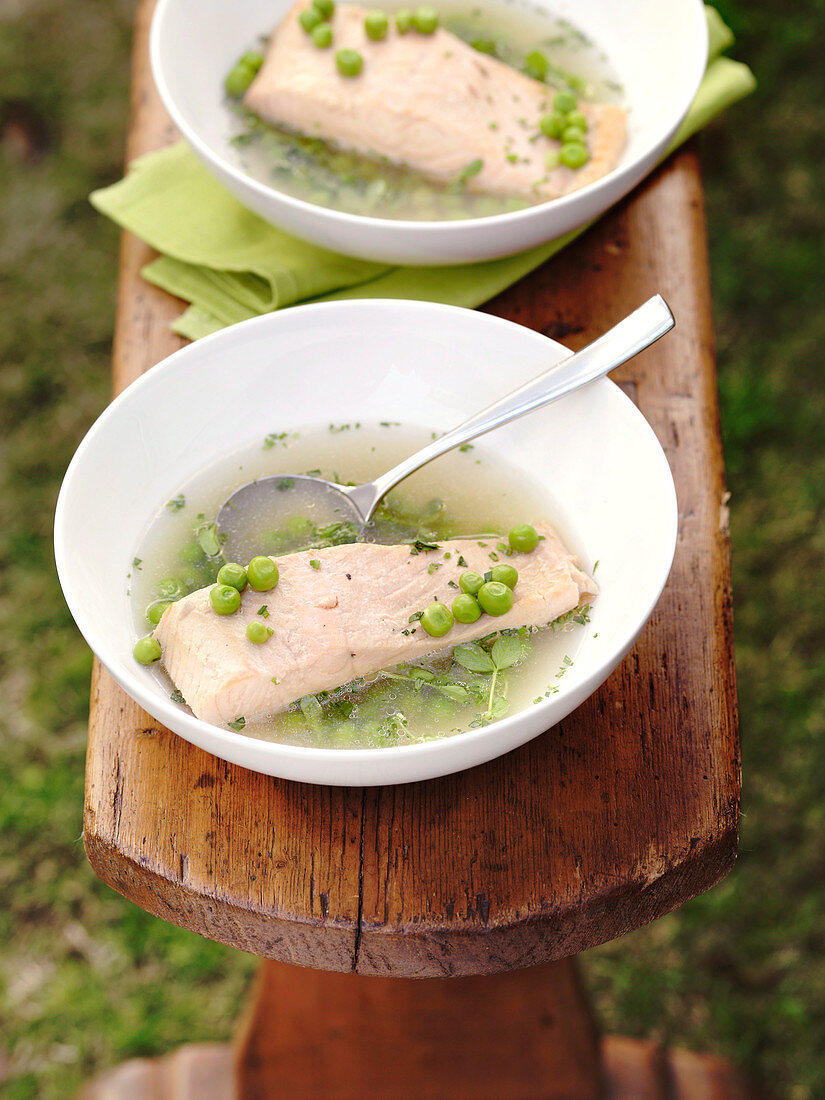 Herb and pea soup with poached salmon