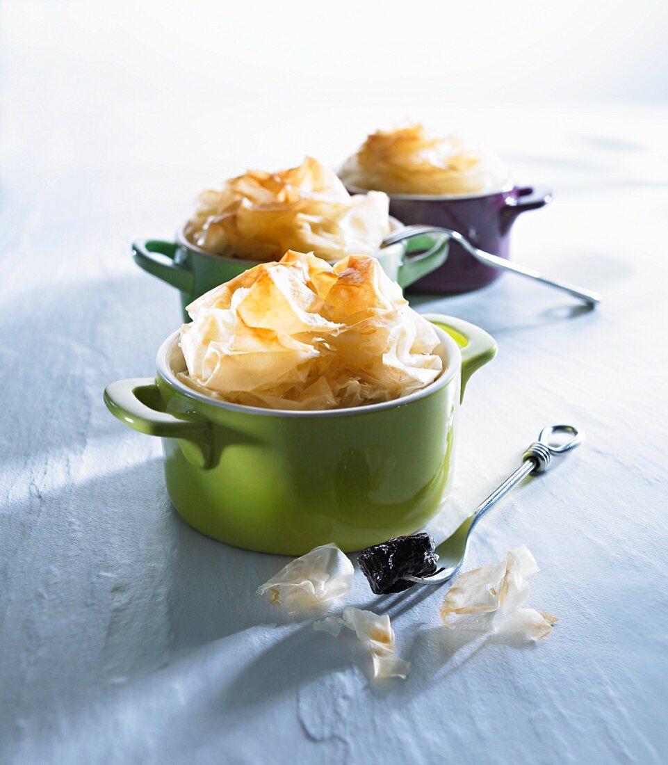 Apple dessert with filo pastry top in miniature cocotte dishes