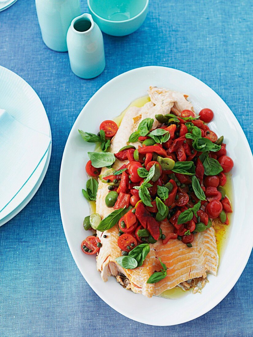 Grilled salmon with cherry tomatoes, olives and basil