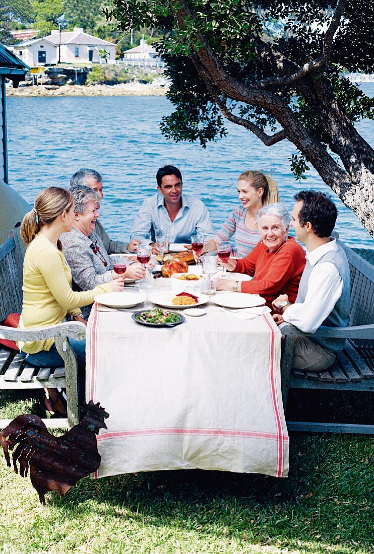 Family eating together on Mother's Day by the ocean (Sicily)