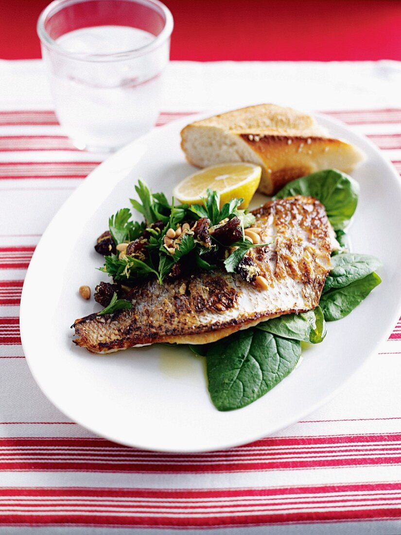Fried fish with lemons and spinach salad