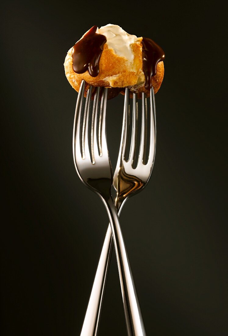 Chocolate profiterole on two forks