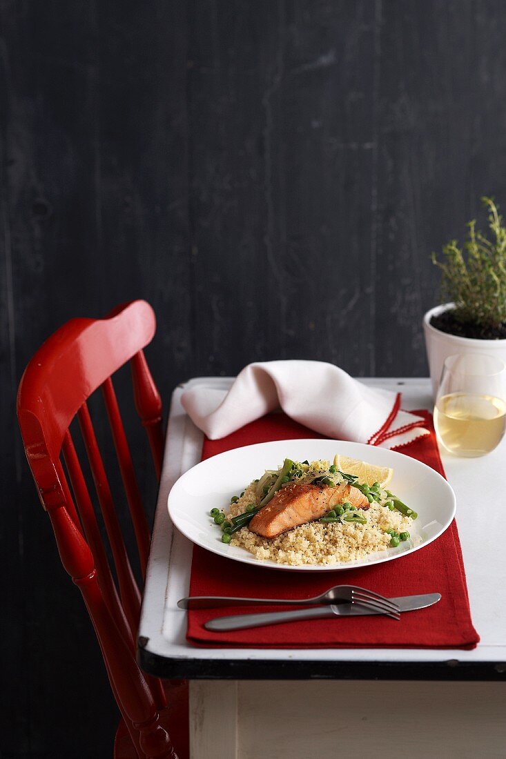 Salmon fillet with peas and beans on couscous