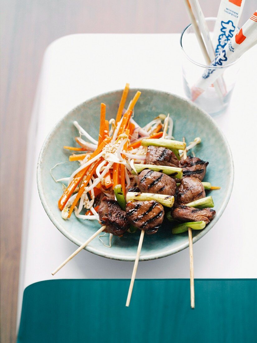 Teriyaki lamb skewers with carrot and bean sprout salad