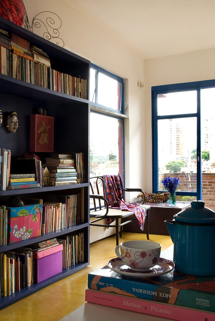 Blue bookcase in room with yellow polished concrete floor
