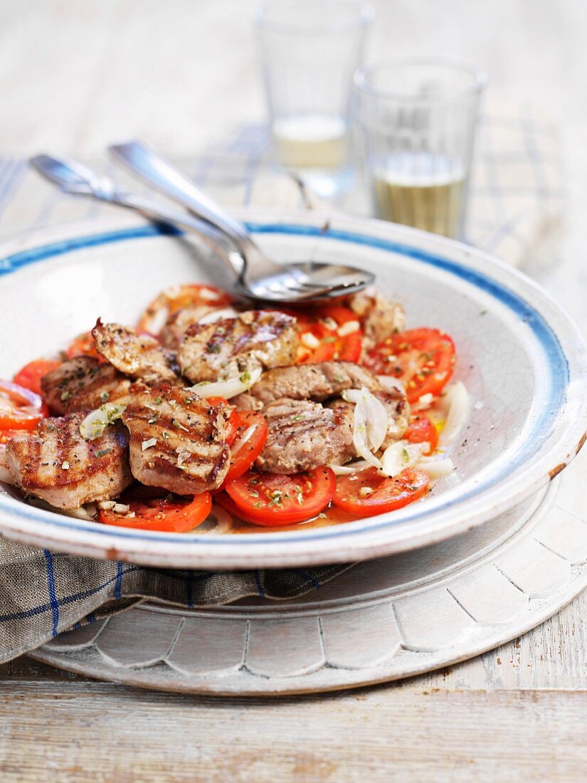 Grilled pork fillet on tomato salad