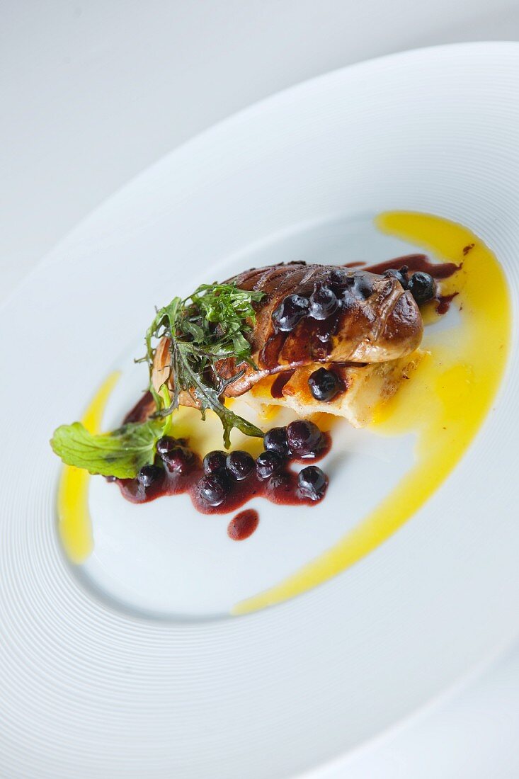 Goose liver with butter sauce and blueberries