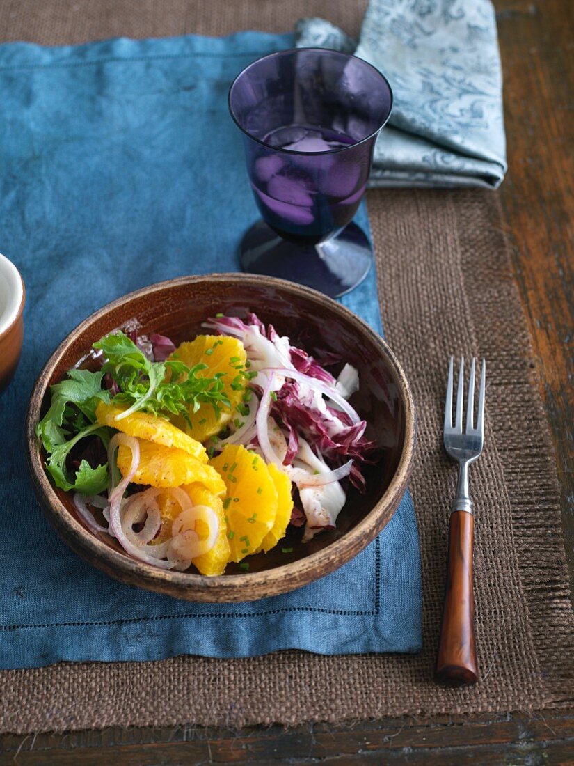 Orange and Red Onion Salad in a Bowl; Fork