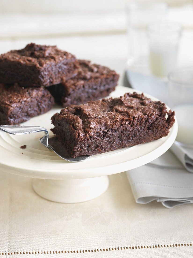 Gluten Free Brownies on a Pedestal Dish; Glasses of Milk