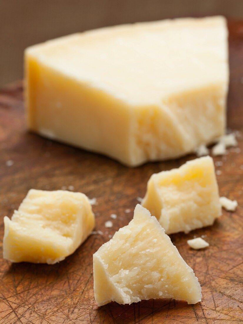 Grana Padano (hard Italian cheese) on wooden board