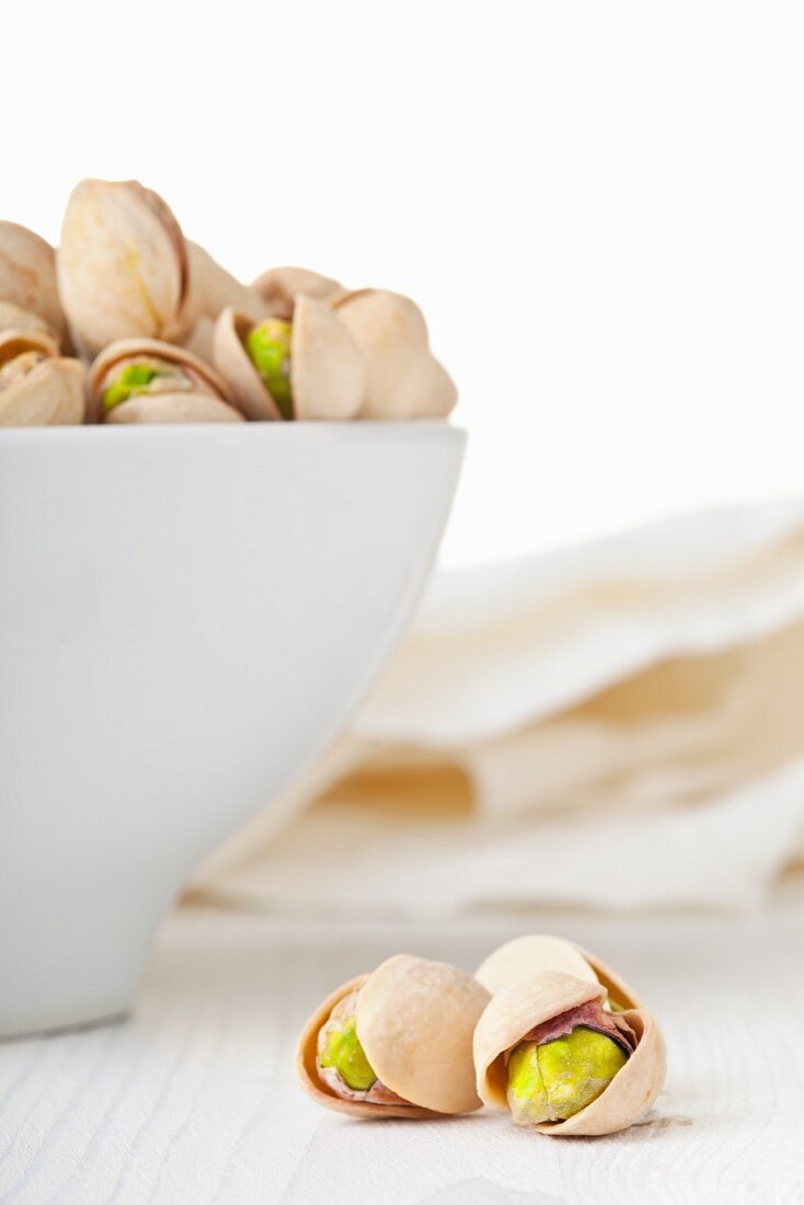 Toasted pistachios in a white bowl