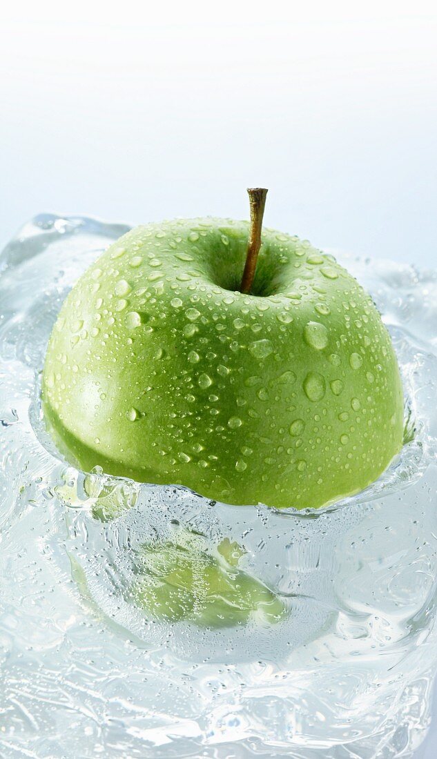 Granny Smith apple in a block of ice