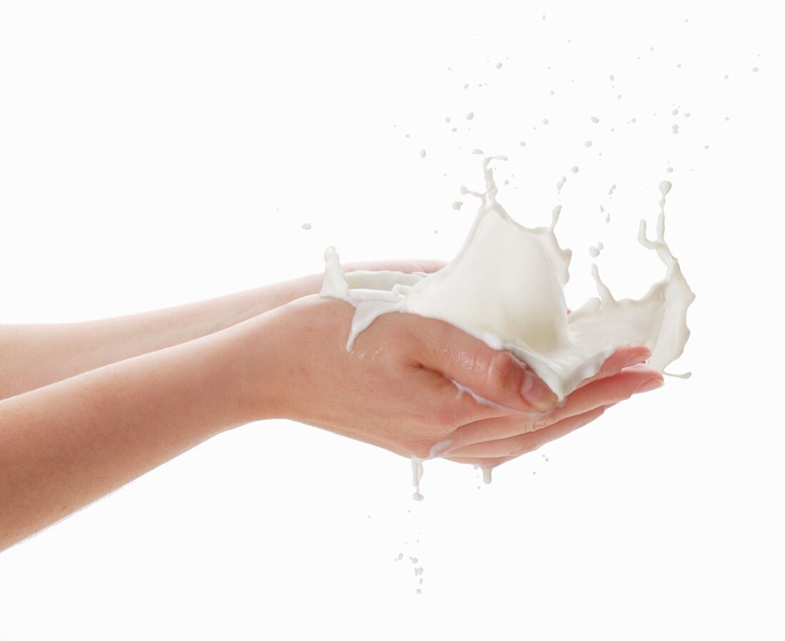 Hands with a milk splash