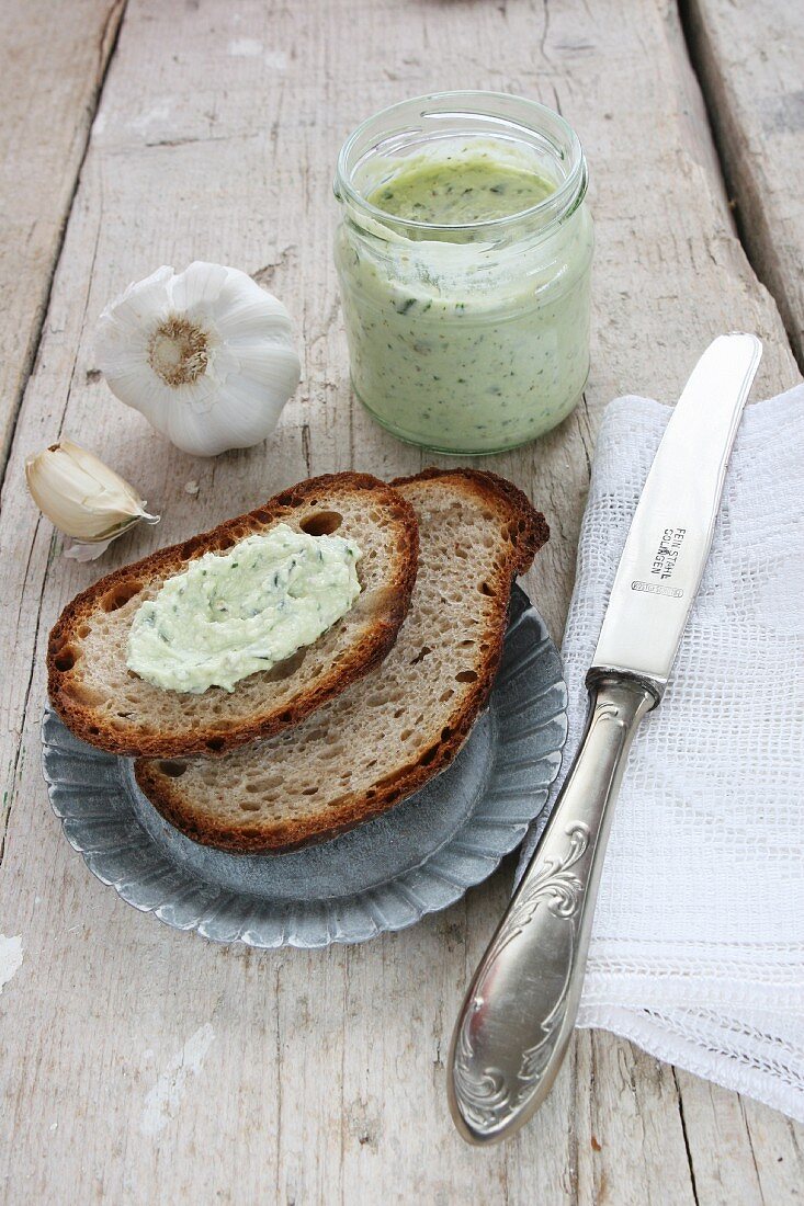 A slice of bread spread with basil and sheep's cheese cream