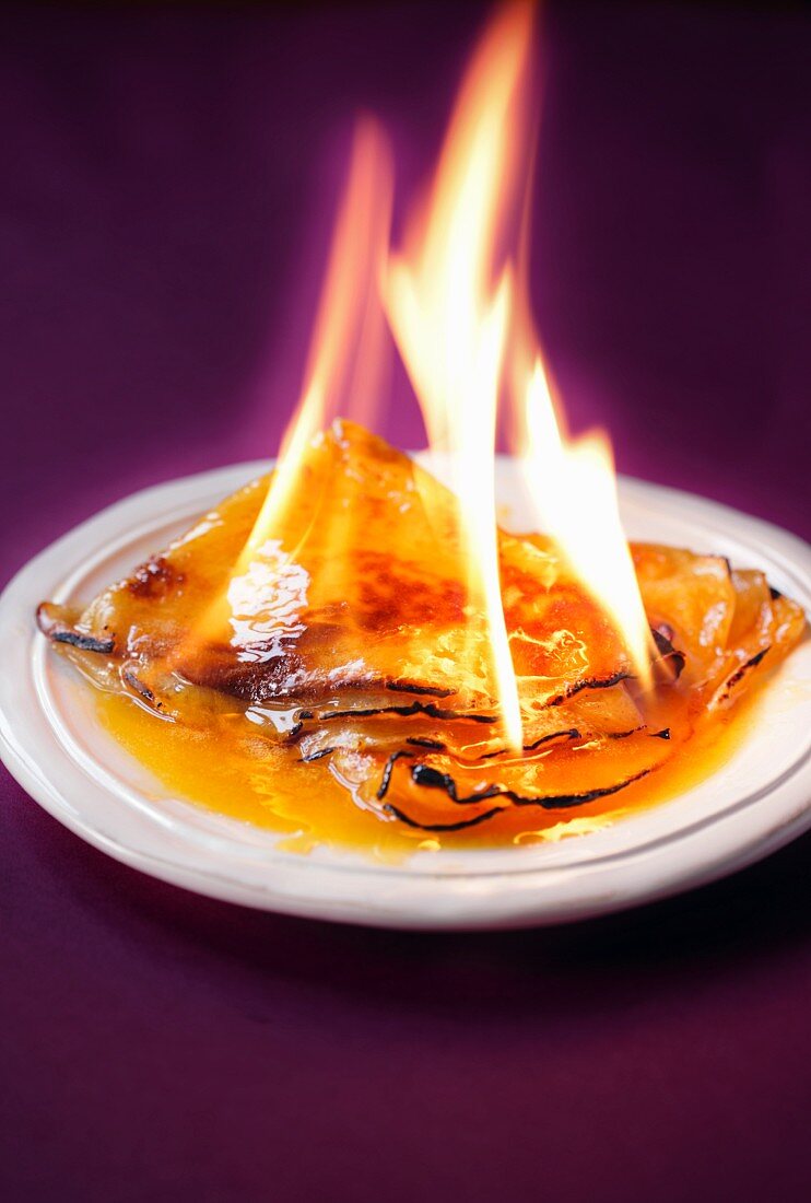 Crepes being flambéed