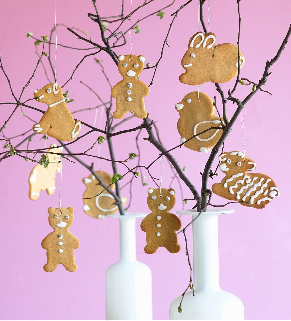 Various Easter biscuits hanging on twigs